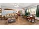 Comfortable living room with a view into the dining area and wood flooring throughout at 9940 Sw 103Rd Pl, Ocala, FL 34481