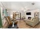 Comfortable living room with a large window, ceiling fan, and sliding doors at 9940 Sw 103Rd Pl, Ocala, FL 34481
