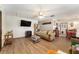 Cozy living room with wood floors, decorative ceiling fan, and comfortable seating at 9940 Sw 103Rd Pl, Ocala, FL 34481