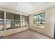 This sunroom features paneled walls and multiple windows for natural light at 9940 Sw 103Rd Pl, Ocala, FL 34481