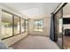 This sunroom boasts natural light through large windows and sliding glass doors at 9940 Sw 103Rd Pl, Ocala, FL 34481