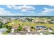 Aerial view of a neighborhood community, showcasing the well-maintained homes and golf course at 5245 Nw 21St Loop, Ocala, FL 34482