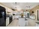 Bright kitchen featuring white cabinetry, tile flooring, a kitchen island with seating, and modern appliances at 5245 Nw 21St Loop, Ocala, FL 34482