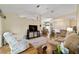 Open-concept living room featuring wood flooring, neutral decor, and views into the dining area at 5245 Nw 21St Loop, Ocala, FL 34482