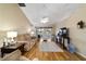 Bright living room with wood flooring, neutral decor, ceiling fan, and sliding glass doors to the outdoors at 5245 Nw 21St Loop, Ocala, FL 34482