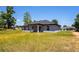 View of the back of the home, highlighting the ample yard space and outdoor living potential at 112 Juniper Run, Ocala, FL 34472