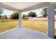 An open back porch overlooks a spacious backyard, perfect for outdoor living and entertaining at 112 Juniper Run, Ocala, FL 34472