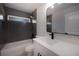 Stylish bathroom features a bathtub with dark tiled wall, and a modern vanity at 112 Juniper Run, Ocala, FL 34472