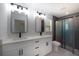 Modern bathroom featuring dual mirrors, elegant fixtures, and a glass-enclosed shower at 112 Juniper Run, Ocala, FL 34472