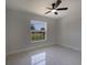 Bright bedroom with a large window, lots of natural light, and sleek flooring at 112 Juniper Run, Ocala, FL 34472