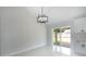 Bright dining space with modern chandelier and sliding glass doors leading to a patio at 112 Juniper Run, Ocala, FL 34472
