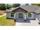 Close-up of the home's entrance showcasing stone accents, an arched entryway, and a modern front door at 112 Juniper Run, Ocala, FL 34472