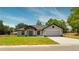 Charming single-story home featuring a two-car garage, well-manicured lawn, and welcoming front entrance at 112 Juniper Run, Ocala, FL 34472