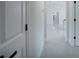 Bright hallway with neutral walls, modern gray tile flooring, and white trim at 112 Juniper Run, Ocala, FL 34472