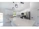 Modern kitchen featuring quartz countertops, stainless steel appliances, and sleek white cabinetry at 112 Juniper Run, Ocala, FL 34472