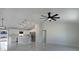 Bright, open-concept living space featuring high ceilings, modern lighting, and seamless flow to the kitchen at 112 Juniper Run, Ocala, FL 34472