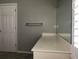 Clean bathroom with a modern vanity, large mirror and door at 11411 Sw 138Th Ln, Dunnellon, FL 34432