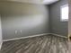 Cozy bedroom with wood-look tile flooring, neutral paint, and bright window at 11411 Sw 138Th Ln, Dunnellon, FL 34432