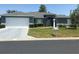 Charming single-story home with well-maintained lawn, gray roof and a two-car garage at 11411 Sw 138Th Ln, Dunnellon, FL 34432