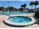 Enjoy a relaxing hot tub with surrounding pool and lounge chairs for a serene experience at 11411 Sw 138Th Ln, Dunnellon, FL 34432