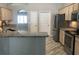 Kitchen featuring granite countertops, stainless appliances, white cabinets and modern flooring at 11411 Sw 138Th Ln, Dunnellon, FL 34432