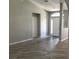 Spacious living room featuring beautiful wood-look tile and neutral color palette at 11411 Sw 138Th Ln, Dunnellon, FL 34432