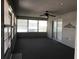 Relaxing sun room featuring large windows, ceiling fan, and tiled flooring at 11411 Sw 138Th Ln, Dunnellon, FL 34432