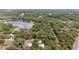 Aerial view of property with surrounding trees and serene lake, ideal for privacy at 1179 Se 170Th Ct, Silver Springs, FL 34488