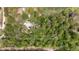 Aerial view of home surrounded by lush trees, featuring a pool and ample privacy at 1179 Se 170Th Ct, Silver Springs, FL 34488