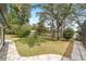 Expansive backyard with brick-paved patio, lush lawn, and mature trees near the lake at 1179 Se 170Th Ct, Silver Springs, FL 34488
