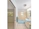 Cozy bathroom featuring retro blue fixtures and tile adjacent to bedroom at 1179 Se 170Th Ct, Silver Springs, FL 34488
