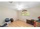 Well-lit bedroom featuring paneled walls, wood floor and a ceiling fan at 1179 Se 170Th Ct, Silver Springs, FL 34488