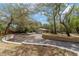 Long driveway leading to a home surrounded by mature trees and lush landscaping at 1179 Se 170Th Ct, Silver Springs, FL 34488