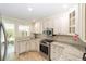 Bright kitchen featuring stainless appliances, granite countertops, and custom white cabinetry at 1179 Se 170Th Ct, Silver Springs, FL 34488