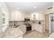 Bright kitchen featuring granite countertops, stainless appliances, and custom white cabinetry at 1179 Se 170Th Ct, Silver Springs, FL 34488