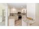 Charming kitchen featuring granite counters, stainless appliances, and custom white cabinetry at 1179 Se 170Th Ct, Silver Springs, FL 34488