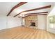 The living room has hardwood floors, exposed beams, natural lighting, and a stone fireplace at 1179 Se 170Th Ct, Silver Springs, FL 34488