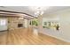 Open living room with wood floors, stone fireplace, wood beam ceiling, and lots of natural light at 1179 Se 170Th Ct, Silver Springs, FL 34488