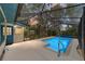 A screened-in in-ground pool features tiled edges and clear water for a refreshing outdoor space at 1179 Se 170Th Ct, Silver Springs, FL 34488