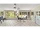 Relaxing sunroom with tile floors, fan, and lots of windows overlooking the backyard pool and lawn at 1179 Se 170Th Ct, Silver Springs, FL 34488
