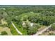Aerial view of home, outbuildings, and the lush surrounding landscape at 14171 Sw 8Th Ave, Ocala, FL 34473