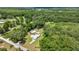 Overhead aerial view of a residence featuring mature vegetation and outbuildings at 14171 Sw 8Th Ave, Ocala, FL 34473