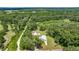 Aerial view of the residence with its surrounding lush greenery and landscape at 14171 Sw 8Th Ave, Ocala, FL 34473