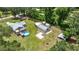 Aerial view of the property, showcasing home, outbuildings and large yard at 14171 Sw 8Th Ave, Ocala, FL 34473