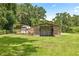 View of the barn with horse shelter and surrounding yard at 14171 Sw 8Th Ave, Ocala, FL 34473