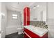 Modern bathroom with white tile walls, a red vanity, and a bathtub with shower at 14171 Sw 8Th Ave, Ocala, FL 34473