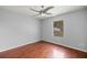 Bedroom features wood floors, closet, light gray walls, and a ceiling fan at 14171 Sw 8Th Ave, Ocala, FL 34473