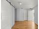 Bedroom features wood floors, closet, and a door leading to the entryway at 14171 Sw 8Th Ave, Ocala, FL 34473