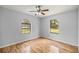Bright bedroom features laminate floors, light gray walls, and a ceiling fan at 14171 Sw 8Th Ave, Ocala, FL 34473