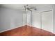 Bedroom features wood floors, closet, and a door leading to the entryway at 14171 Sw 8Th Ave, Ocala, FL 34473